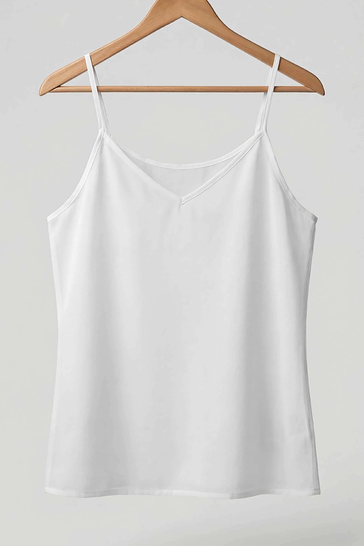 Neechy white short cotton inner slip with a v-neck on a wooden hanger
